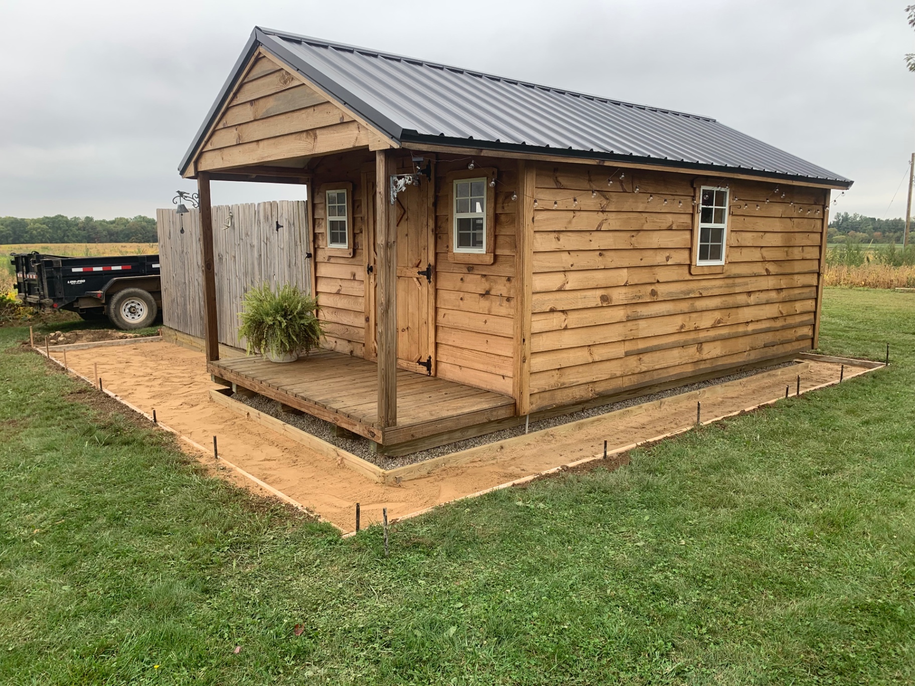 Cedar shed on fresh gravel base ready for concrete